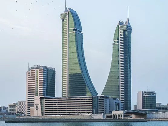 A stunning waterfront view of Bahrain Financial Harbour, with its distinctive twin towers rising gracefully against the skyline—home to Servcorp serviced offices,