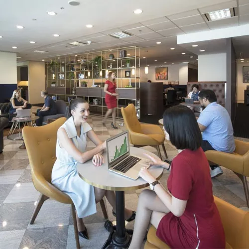 Servcorp Coworking Space with people networking, collaborating, or working at dedicated desks with a luxury fit out.
