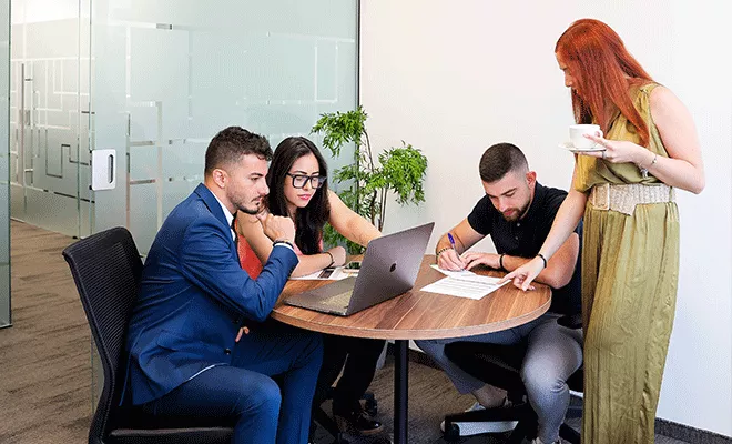Meeting Room at Qubic Square with people meeting and presenting using high-tech, fully equipped facilities.